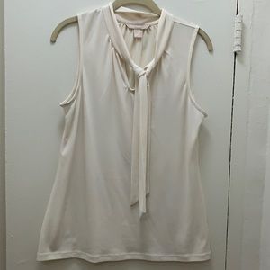 Sleeveless shirt with tie neck